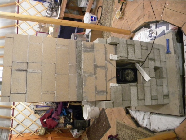 Concrete brick facing partially complete. ~1/4" air gap maintained between the core & facing using cardboard, which is removed after the mortar sets. 