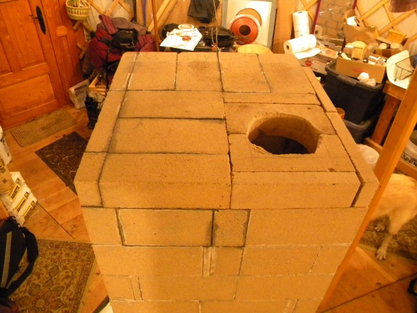 The top, with the chimney/stovepipe hole which still needs some work (right-most bricks not mortared in).