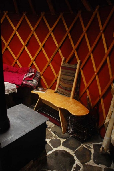 Wood stove & curved Yurt chair.